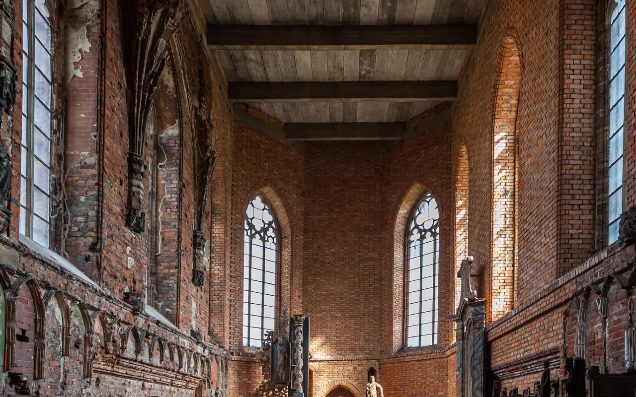 Interior of St Mary's Church at Malbork Castle with tall Gothic windows